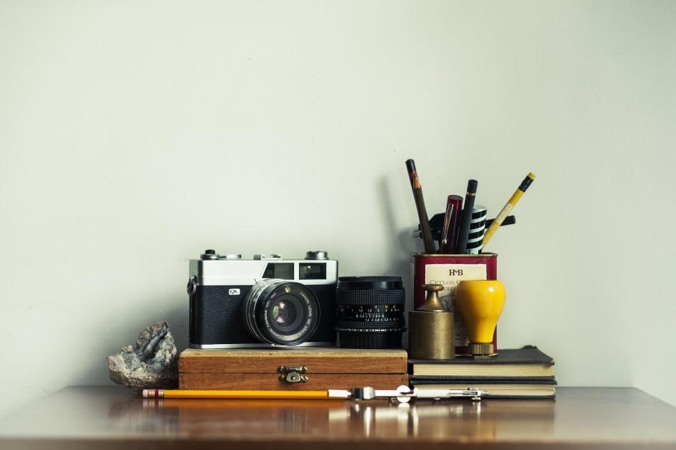 Free Image of Desk With Camera, Pencils, and Other Items 