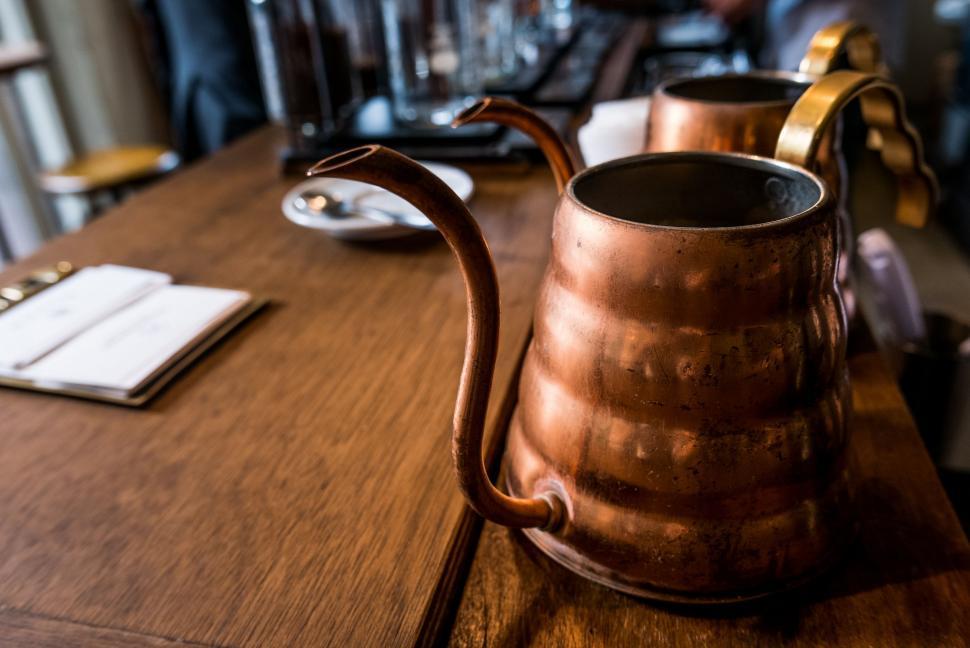 Free Image of Metal Pitcher on Wooden Table 