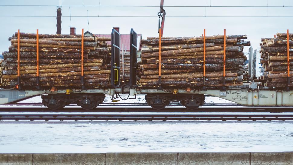 Free Image of Train Car Loaded With Logs on Railroad Tracks 