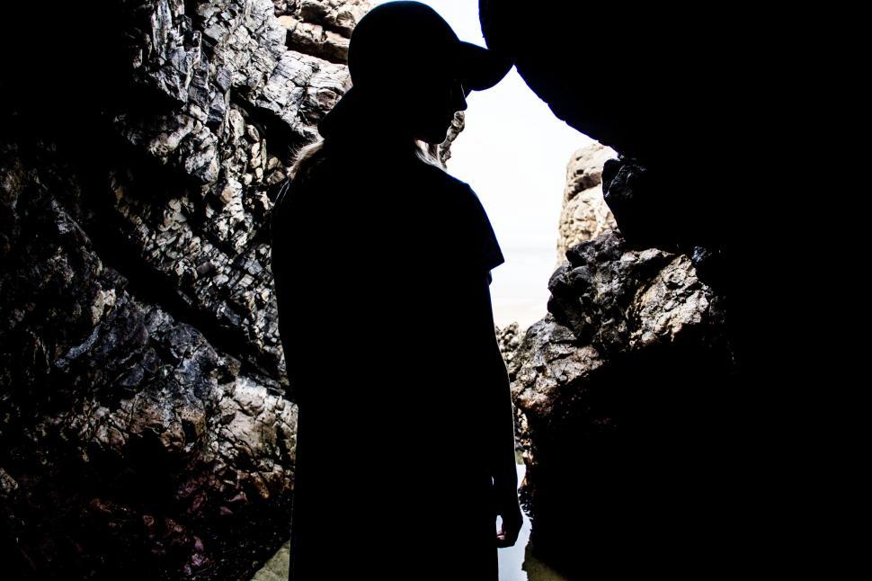 Free Image of Man Standing in Front of Rock Formation 