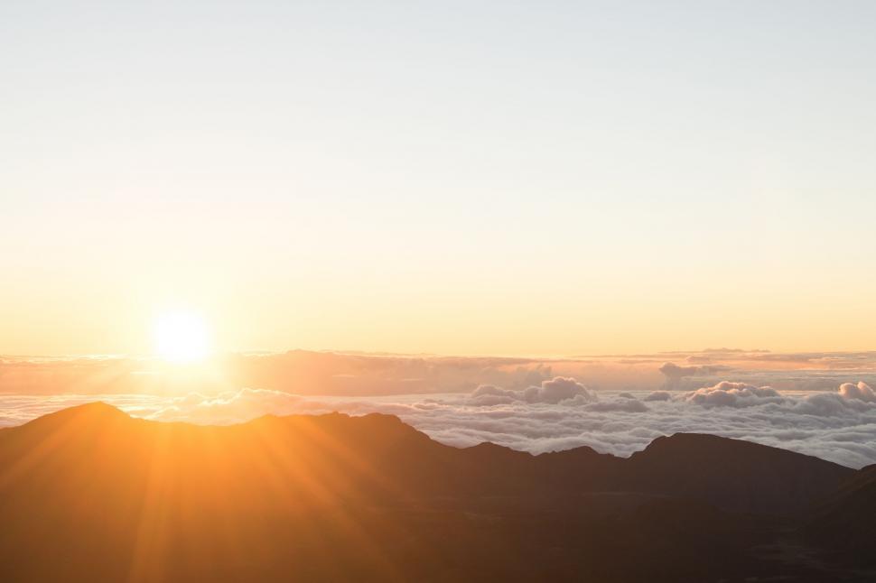 Free Image of Person Standing on Top of Mountain at Sunset 