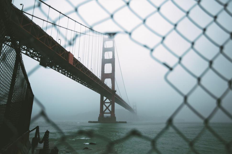 Free Image of View of the Golden Gate Bridge Through a Fence 