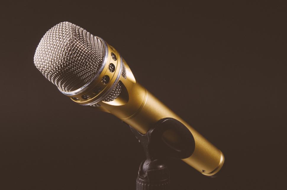 Free Image of A Microphone on a Stand in a Black Background 