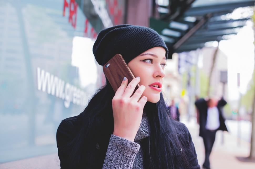 Free Image of Woman Talking on Cell Phone With Beanie 