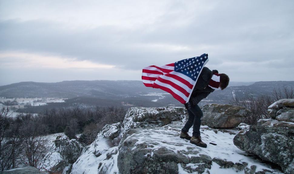 Free Image of Man Holding American Flag on Mountain Top 