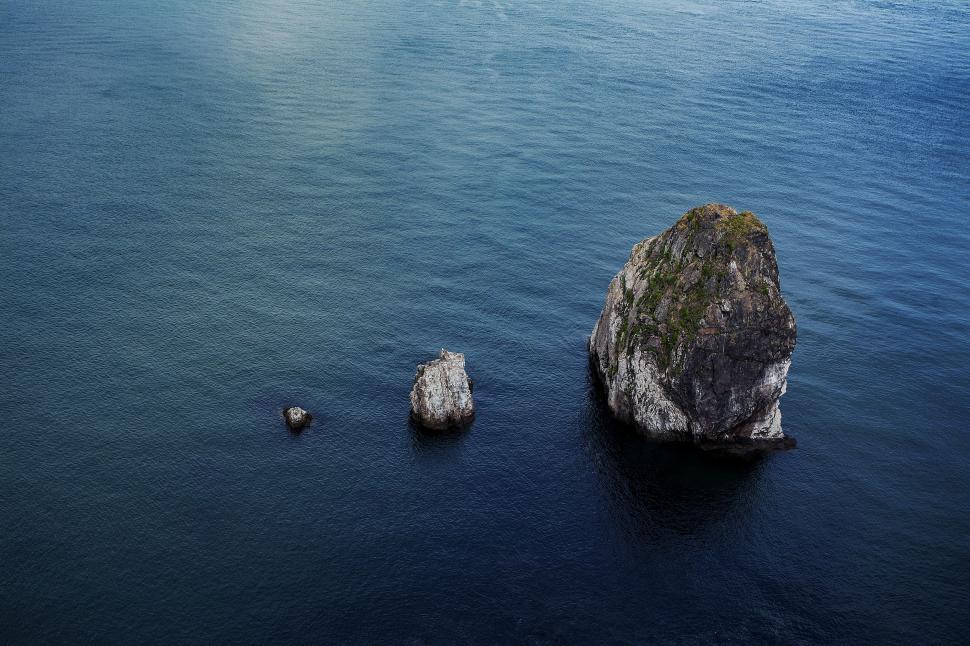 Free Image of Large Rock in the Middle of a Body of Water 
