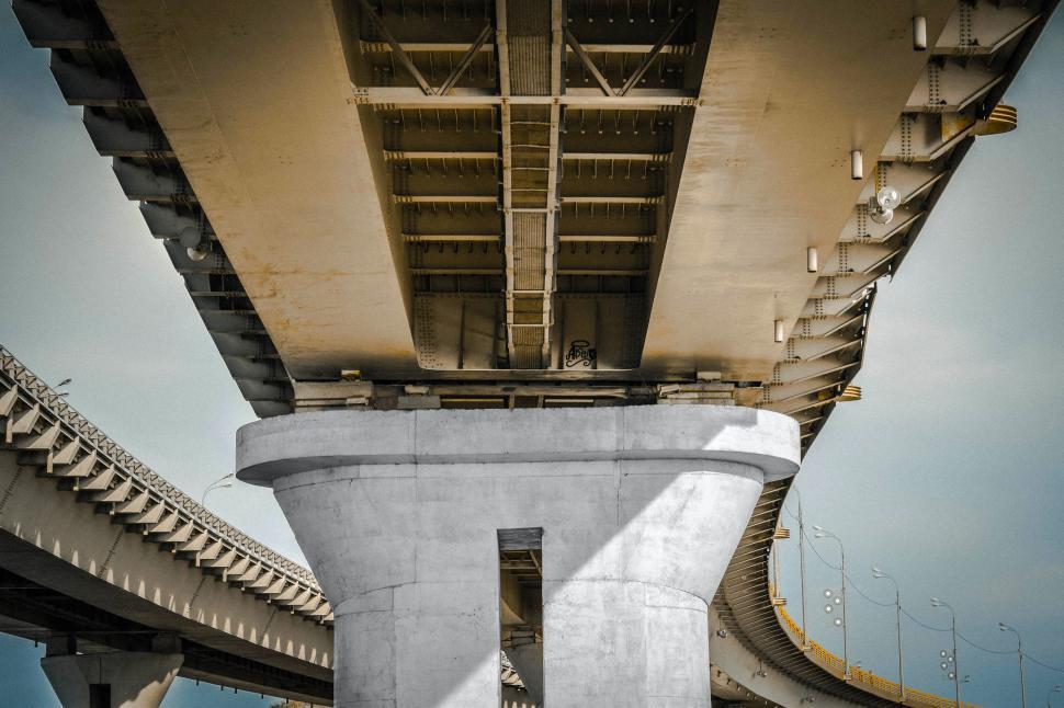 Free Image of The Underside of a Large Bridge With Sky Background 