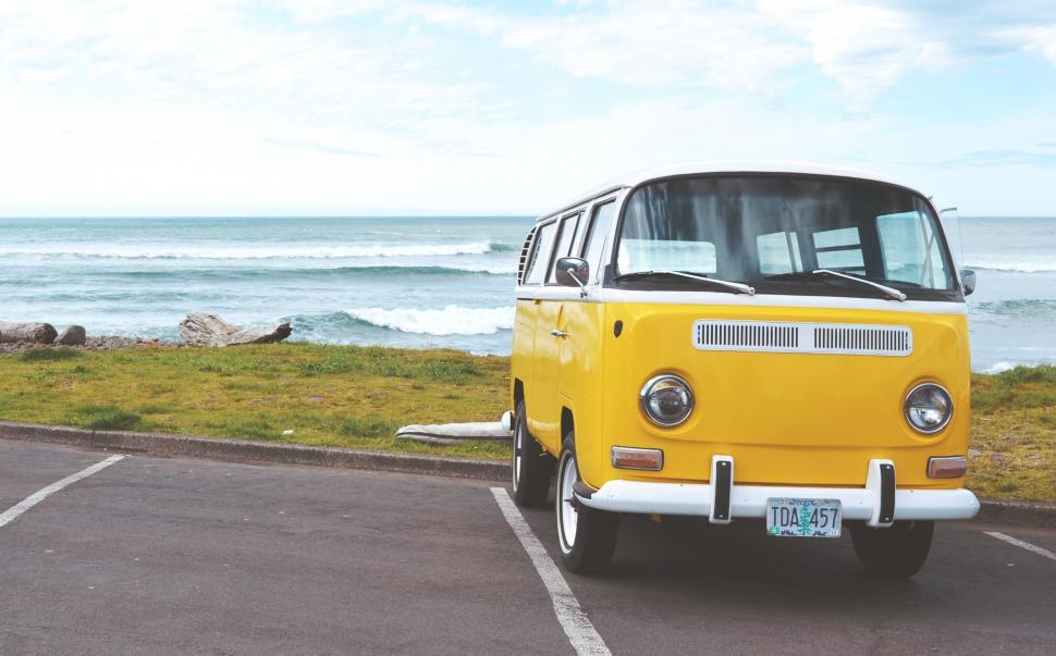Free Image of Yellow Van Parked in Oceanfront Parking Lot 
