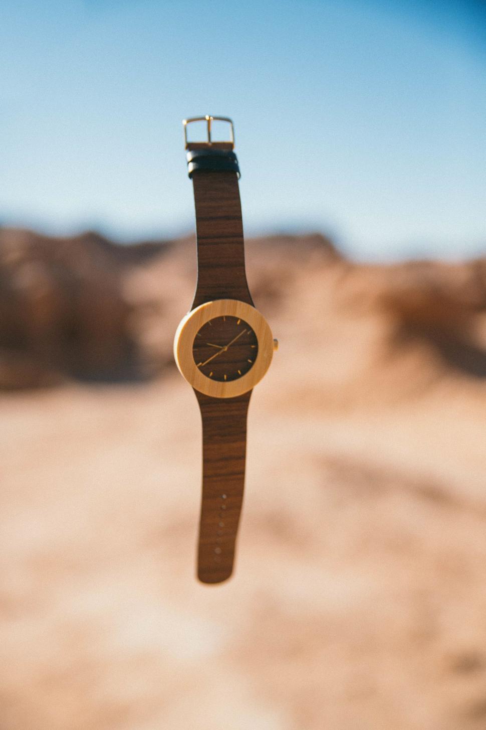 Free Image of Watch Hanging From String in Desert 