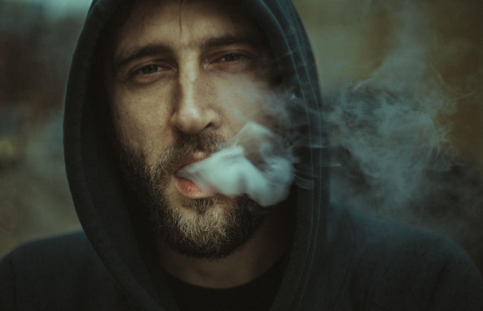 Free Image of Man in Hoodie Smoking Cigarette 