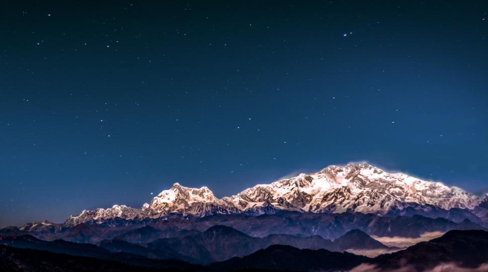 Free Image of Snow Covered Mountain Under Night Sky 