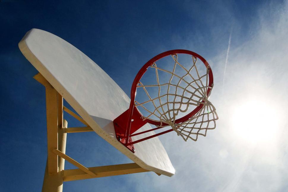 Free Image of basketball hoops net pole sun flare sports backboard basket rim silhouette 