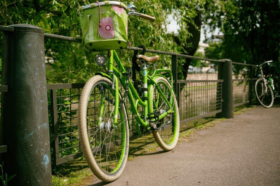 Free Image of Green Bicycle Parked Next to Fence 