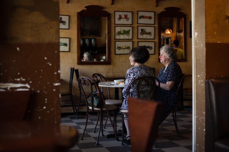 Free Image of Two Women Sitting at a Table in a Restaurant 