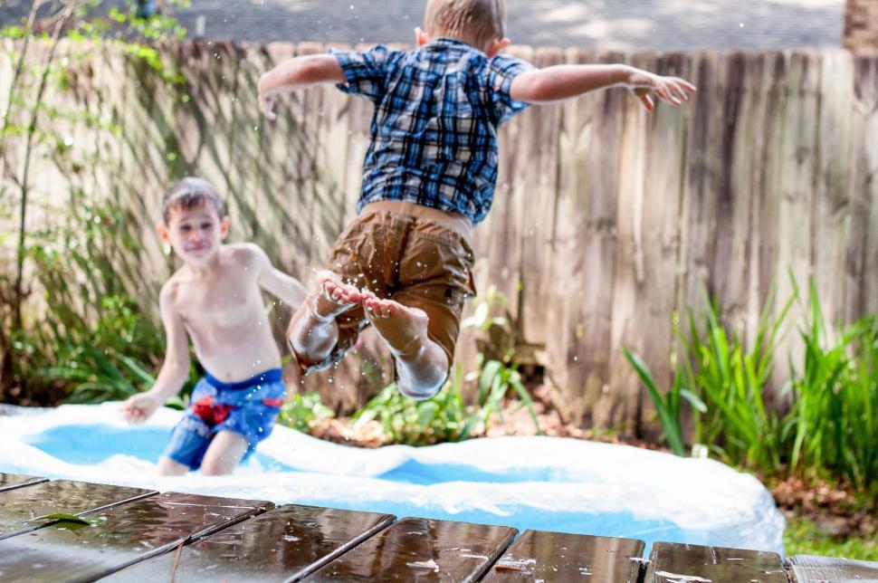 Free Image of Two Young Boys Playing in the Water 