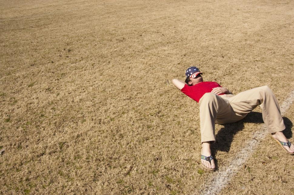 Free Image of Man Lying on Ground in Baseball Field 