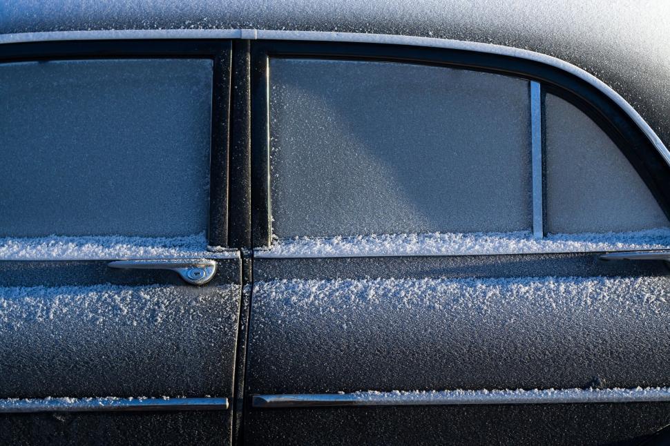 Free Image of Close Up of Car Windshield Covered in Snow 