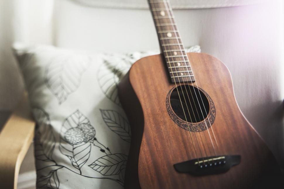 Free Image of Close Up of Guitar on Bed 