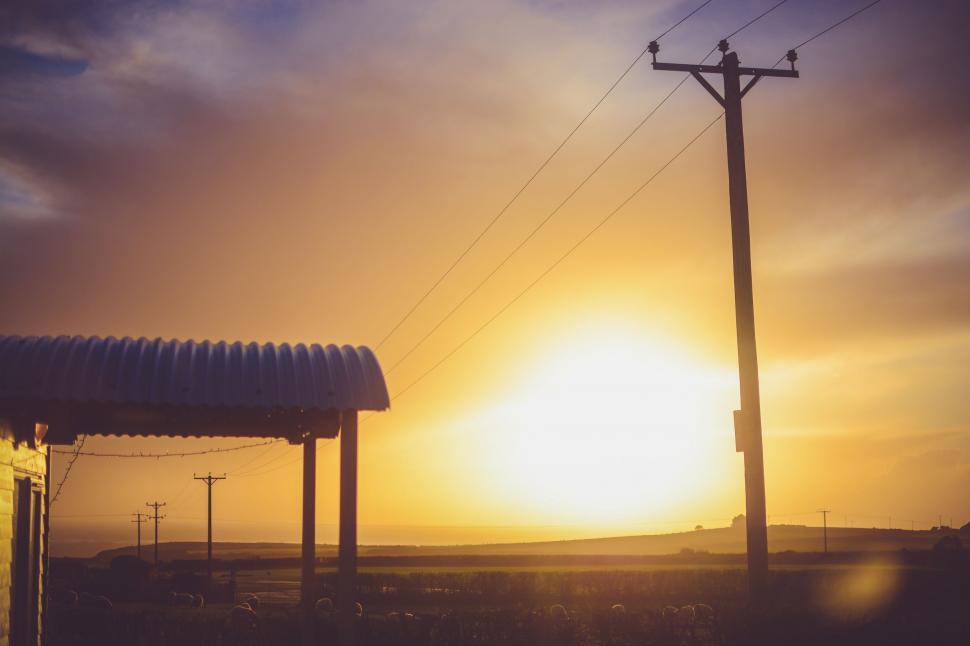 Free Image of Sun Setting Over Gas Station 