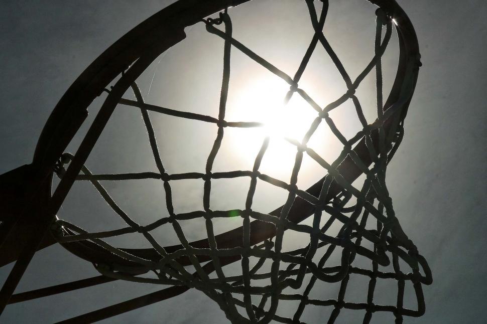 Free Image of basketball hoops net sun flare sports basket rim silhouette clouds 