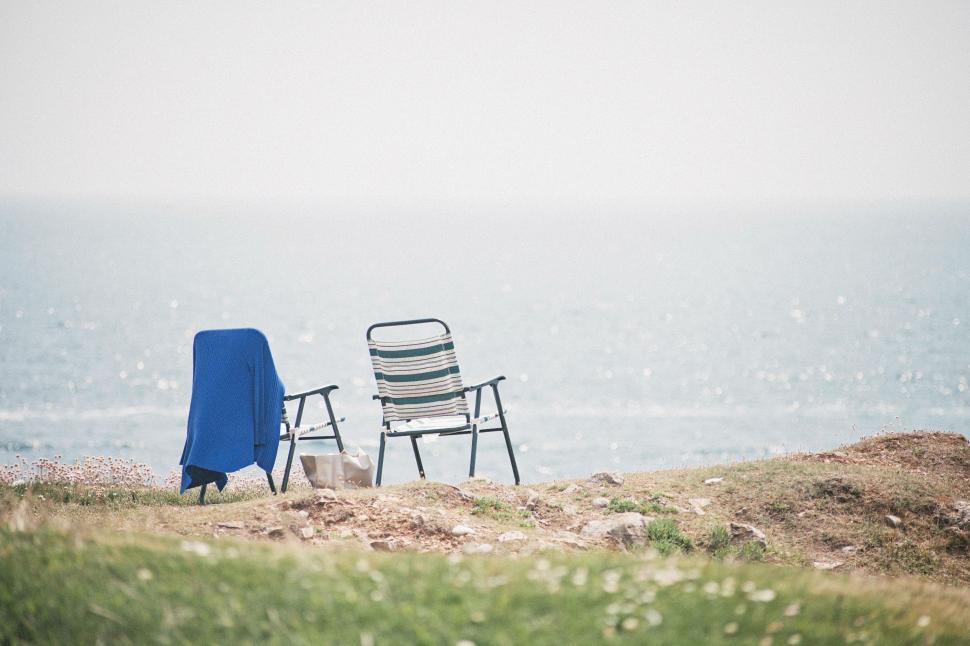 Free Image of Two Chairs on Sandy Beach 