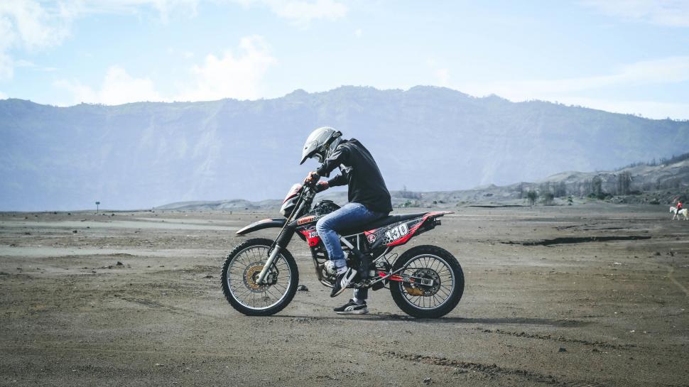 Free Image of Man Riding Dirt Bike on Dirt Field 