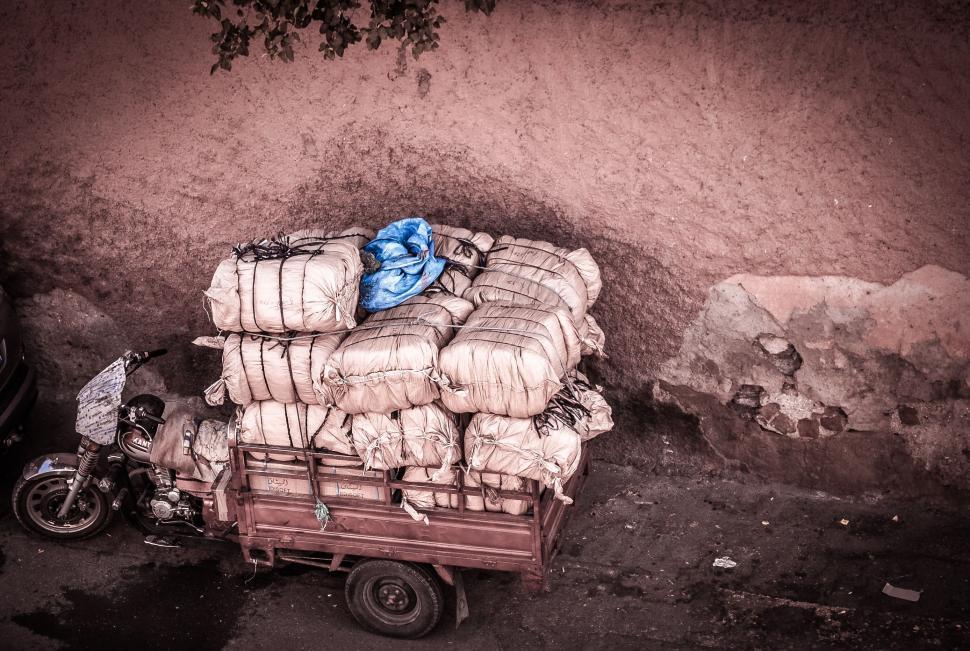 Free Image of Motorcycle Parked Next to Pile of Bags 