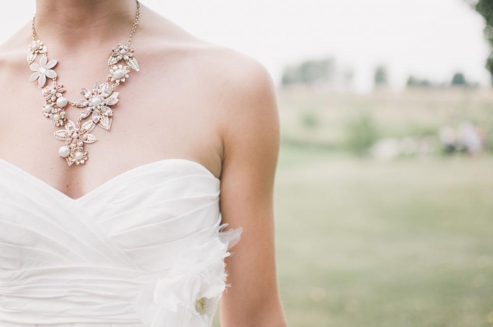 Free Image of Woman in White Dress Wearing Necklace 