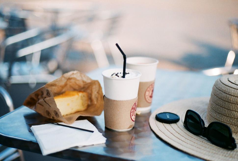 Free Image of Two Cups of Coffee and a Paper Bag on a Table 