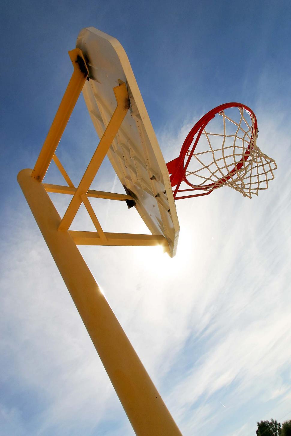 Free Image of Basketball Hoop Soaring Against Blue Sky 