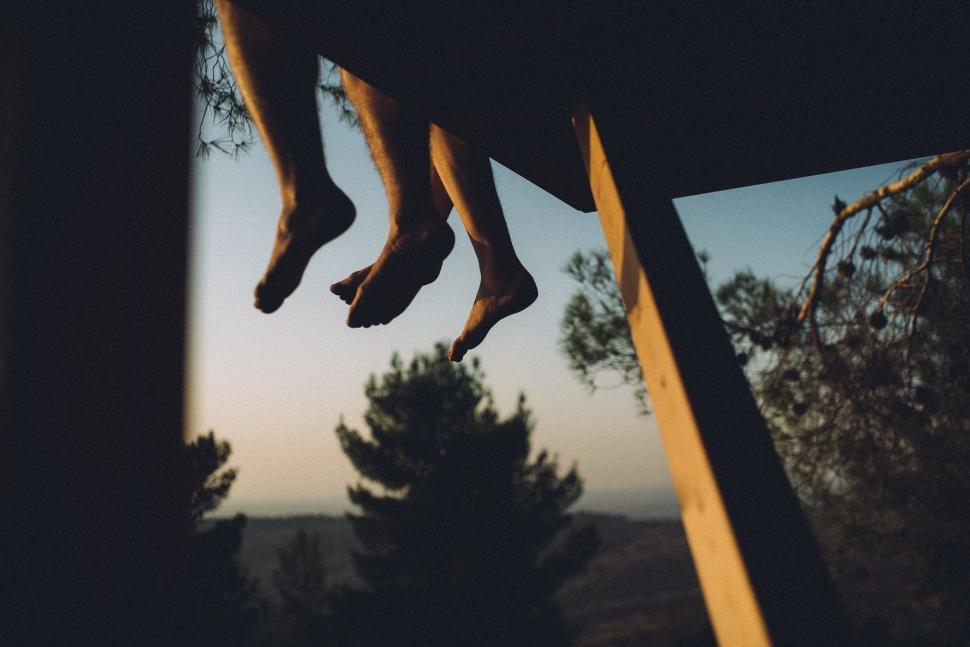 Free Image of Feet Dangling Off Window 