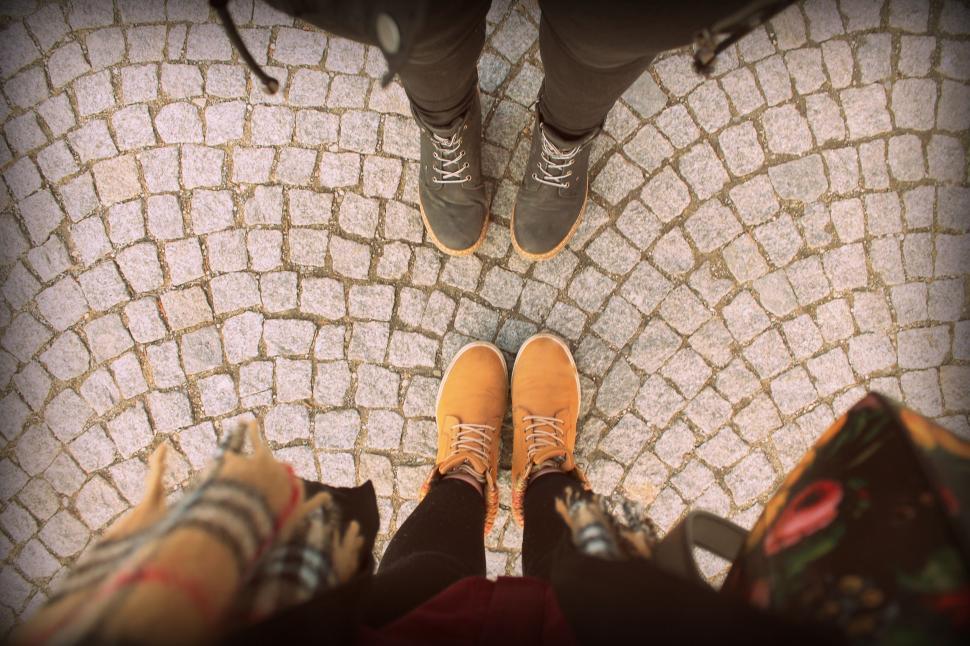 Free Image of Group of People Standing on Top of Cobblestone Floor 