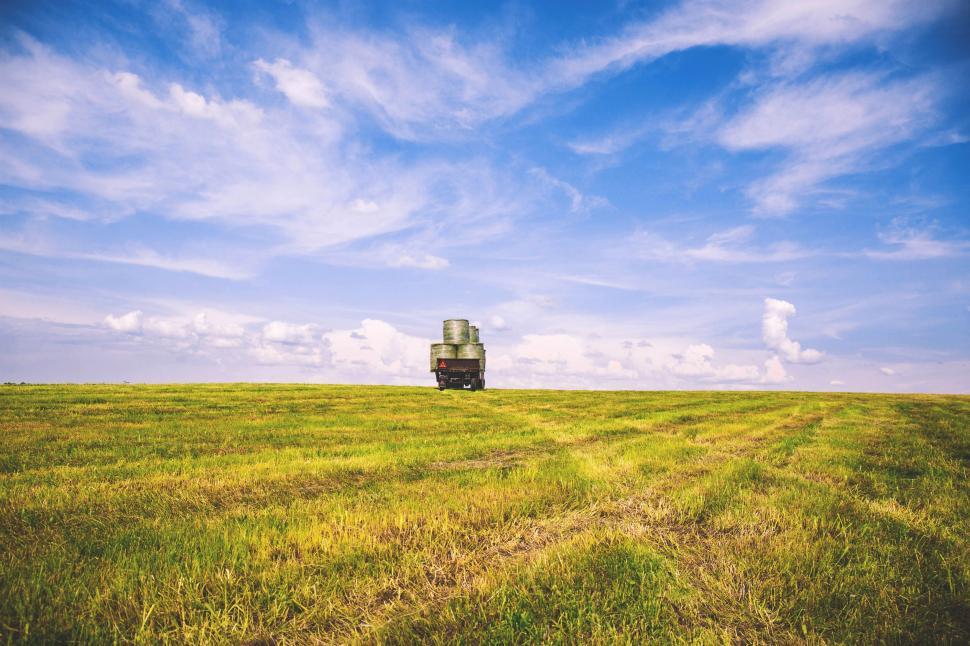 Free Image of Truck Driving Across Lush Green Field 