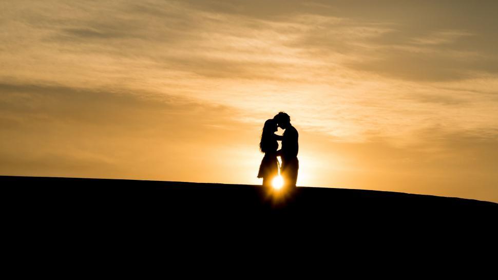 Free Image of Couple Standing on Hilltop 