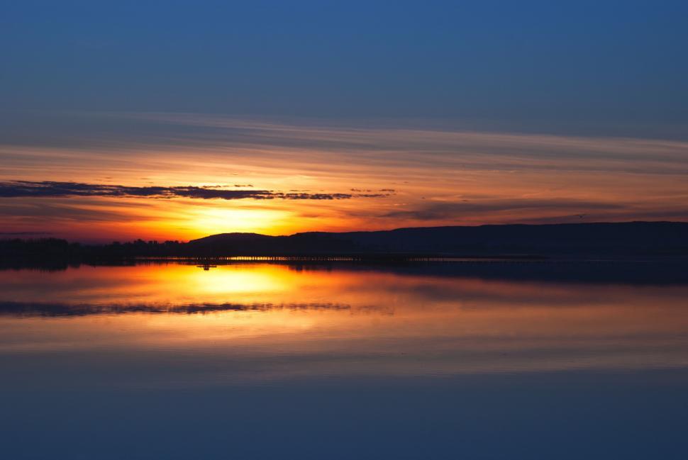 Free Image of Sun Setting Over Calm Lake 