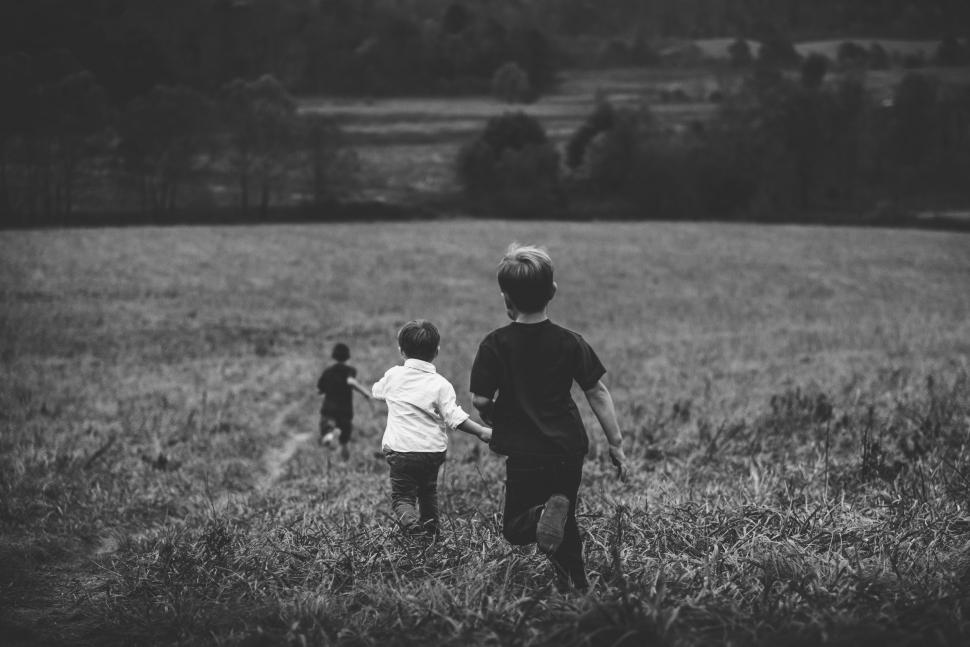 Free Image of Three Children Playing in a Field 