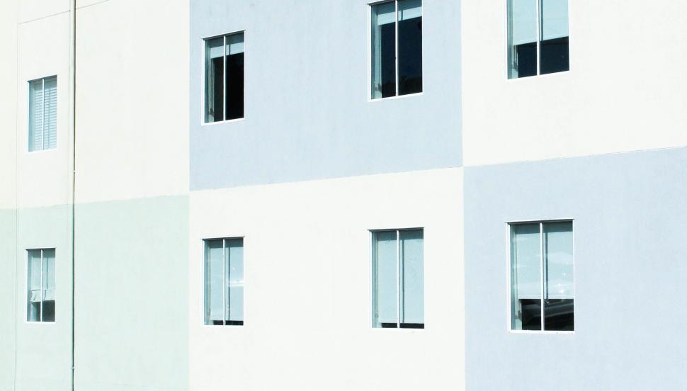 Free Image of Tall White Building With Multiple Windows 