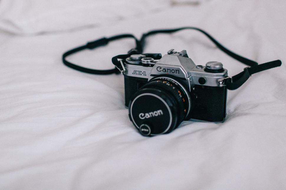 Free Image of Camera Resting on Bed 