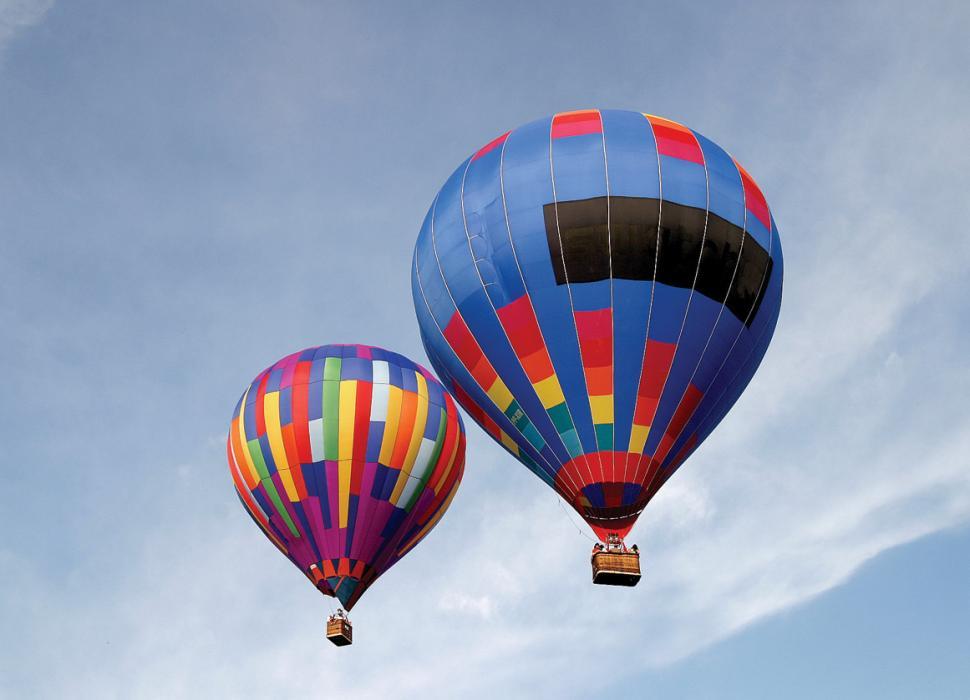 Free Image of Hot Air Balloons Flying Through Blue Sky 