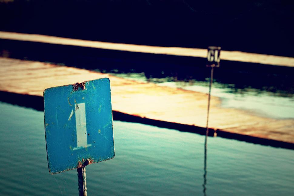 Free Image of Blue Sign by Body of Water 