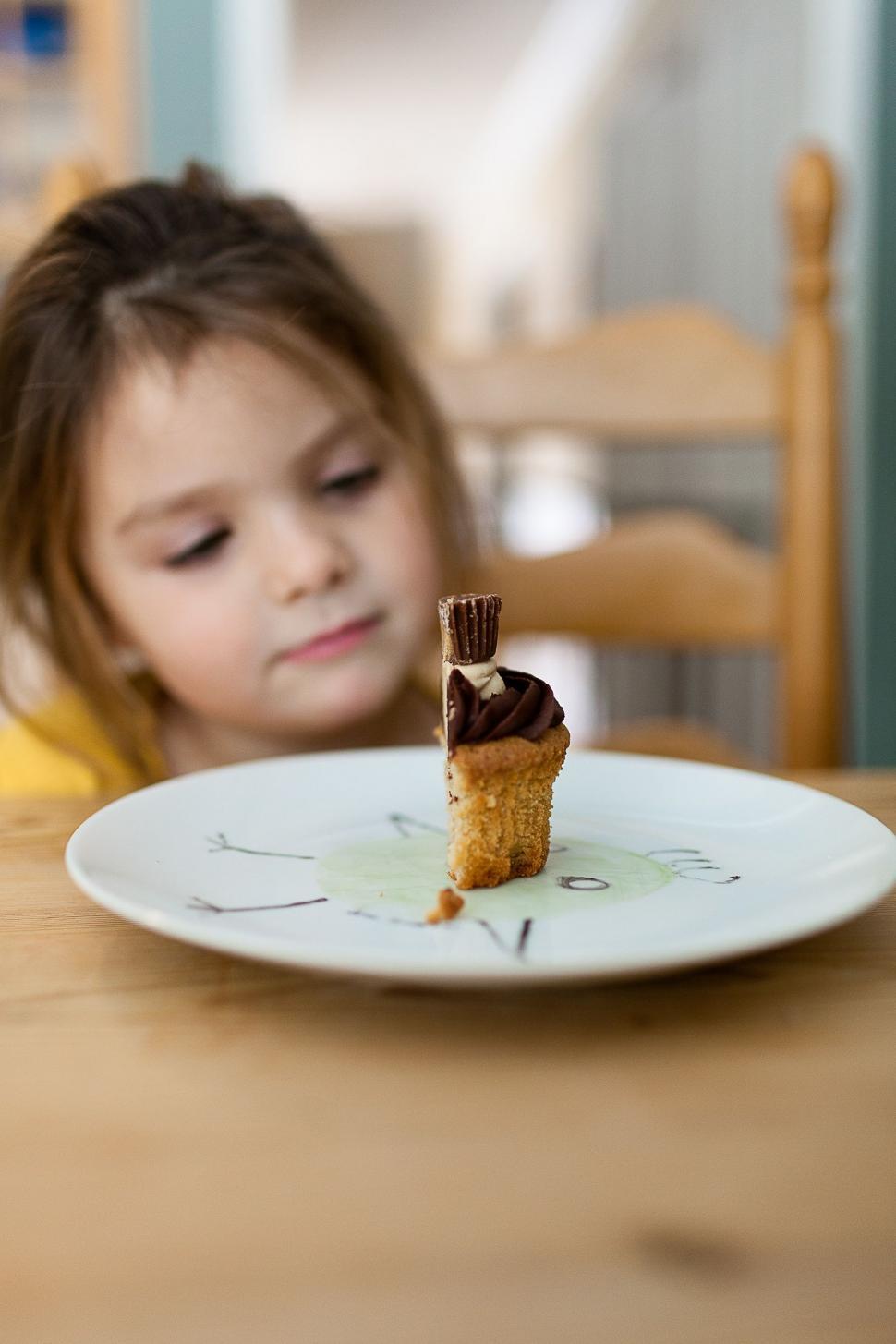 Free Image of Little Girl Sitting at Table With Cake 