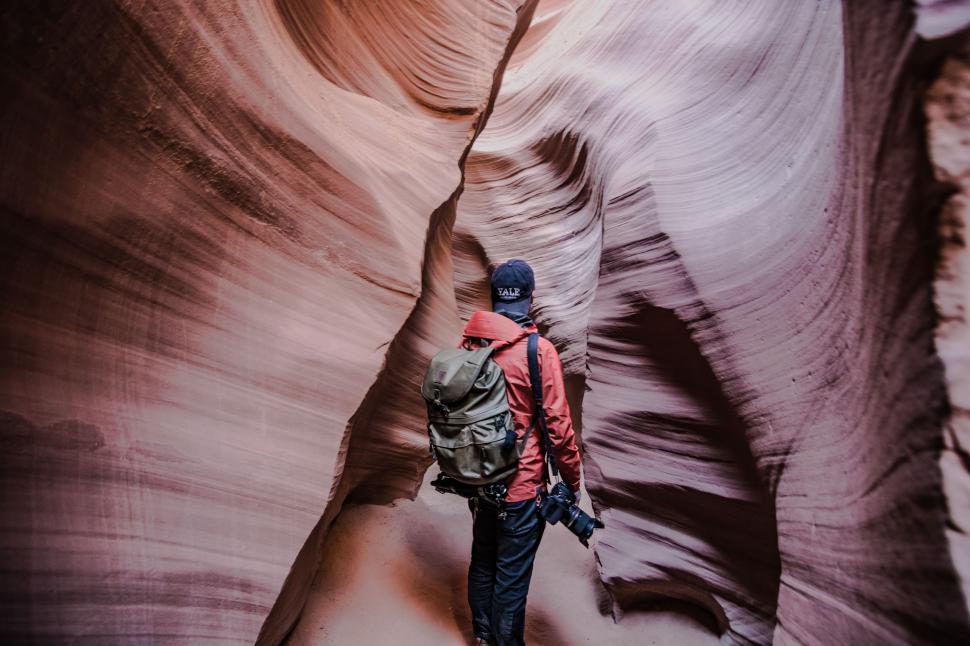 Free Image of Person Walking Through Narrow Slot in Canyon 