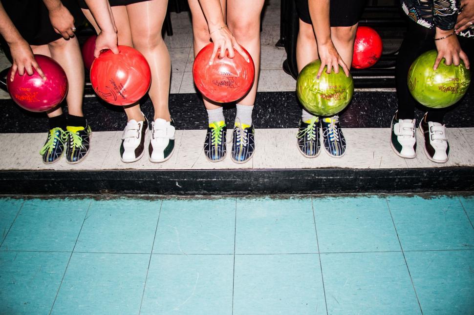 Free Image of Group of People Holding Balls Standing Together 