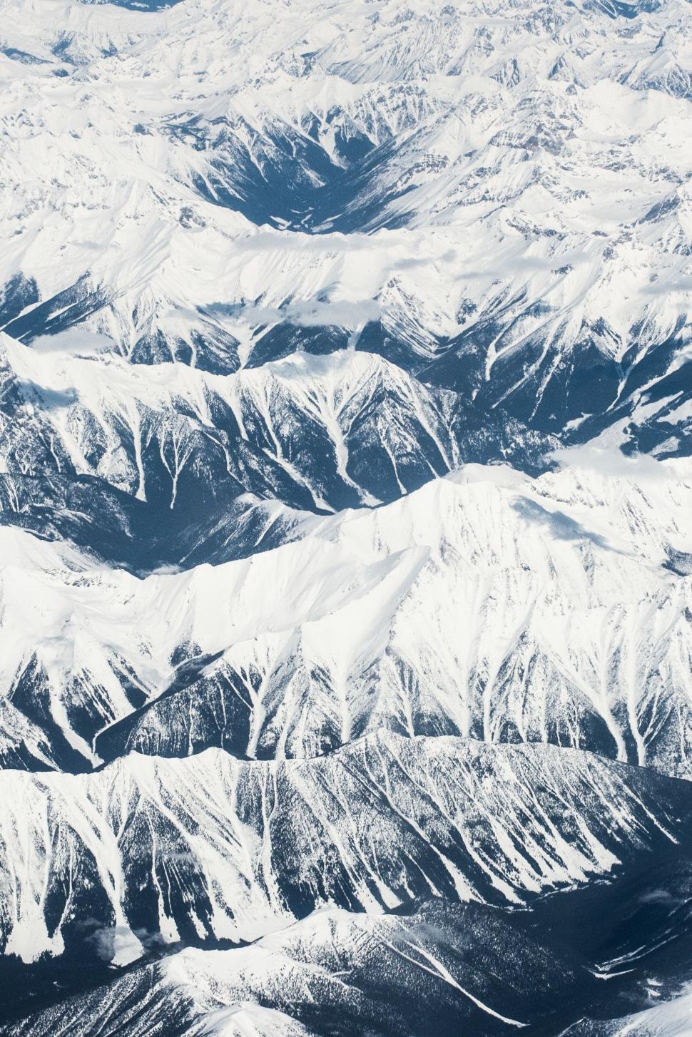 Free Image of Aerial View of Snow Covered Mountains From Airplane 