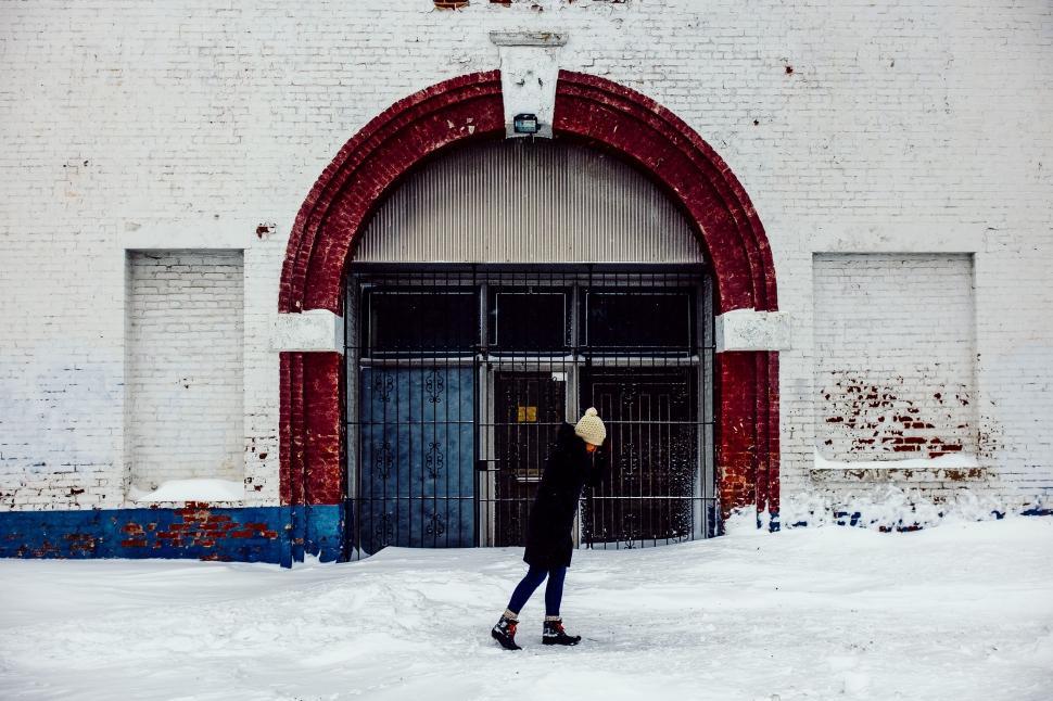 Free Image of Person Standing in Snow in Front of Building 