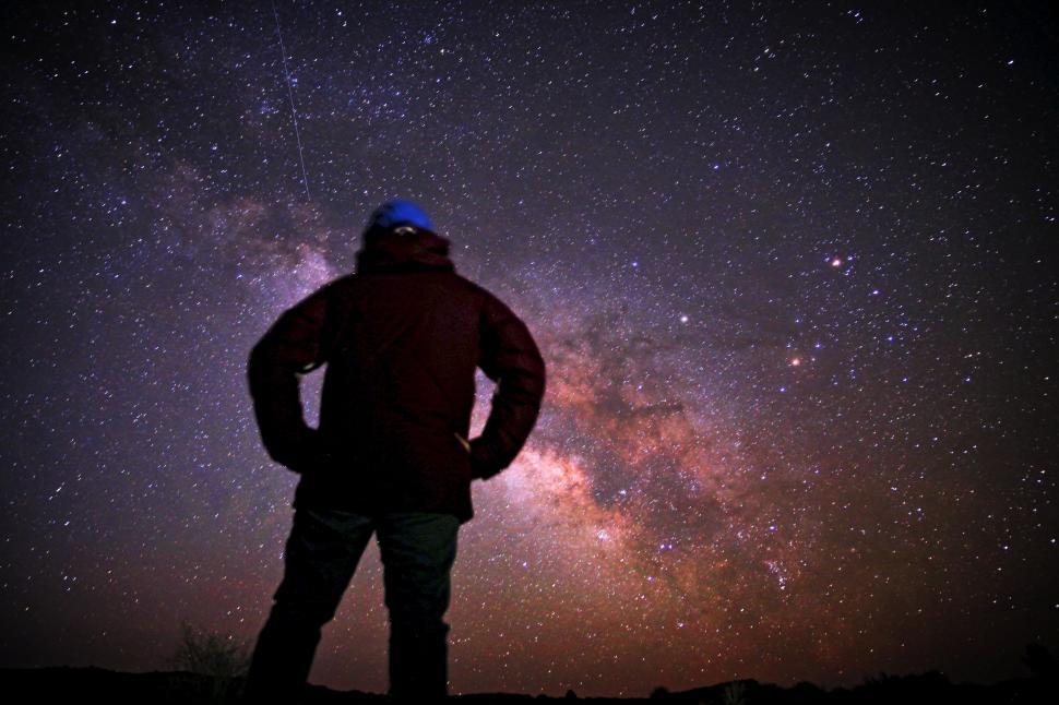 Free Image of Man Standing on Hill Under Starry Night Sky 