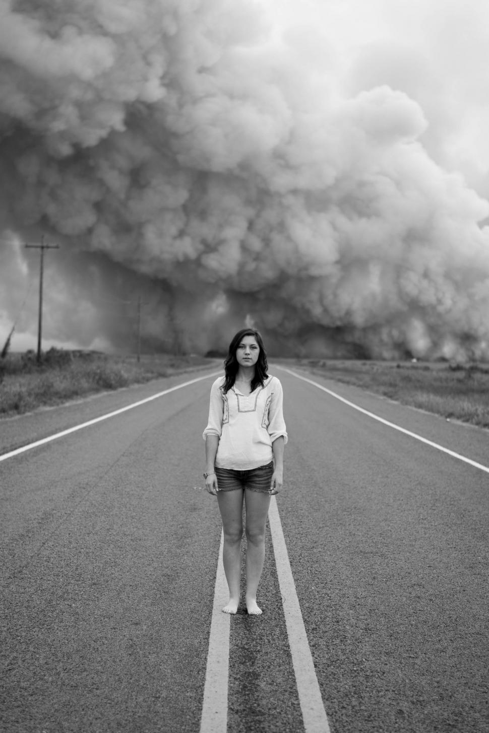 Free Image of Woman Standing in Middle of Road 
