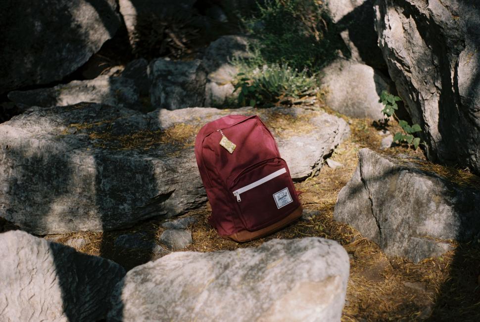 Free Image of Red Backpack on Pile of Rocks 
