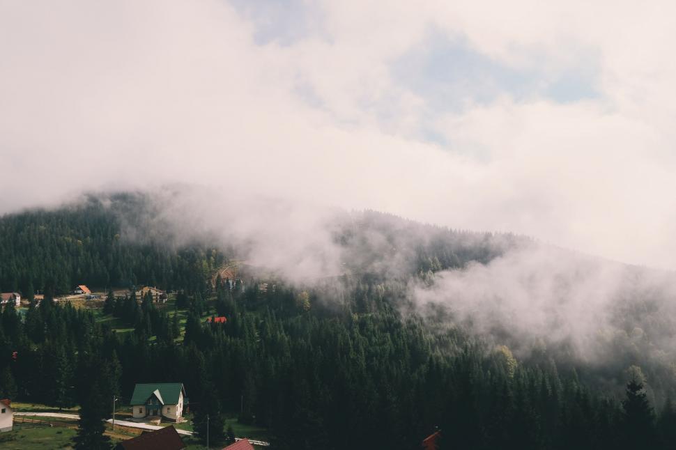 Free Image of Mountain Covered in Clouds and Trees 