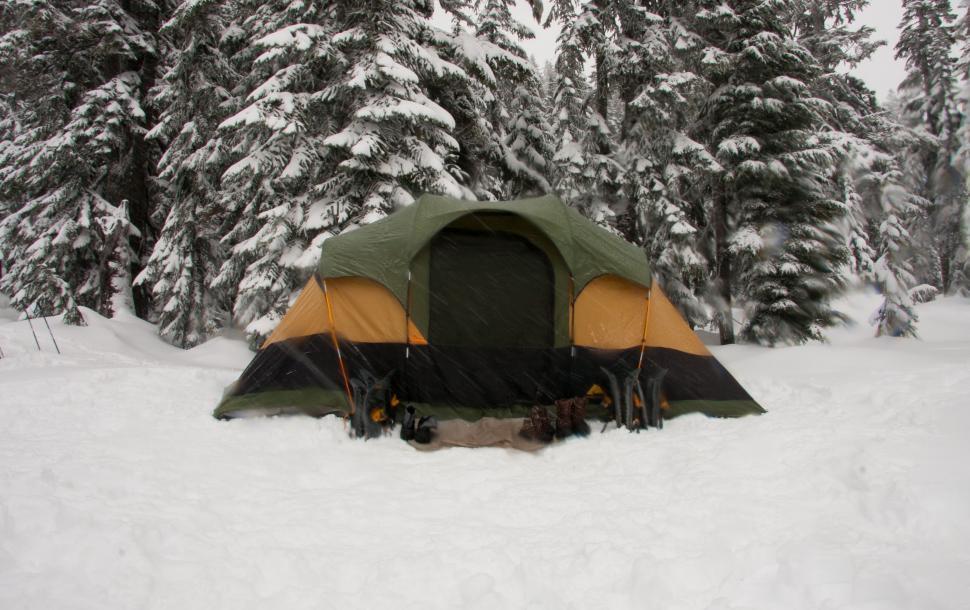 Free Image of Tent in Snow With Background Trees 